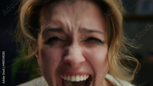 Crying woman shouting, portrait of screaming female person in living room, feeling anger and stress, bad mood. Family problems, aggressive emotional wife quarreling.  photo