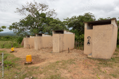 Latrines for primary school students, with buckets of water outside photo