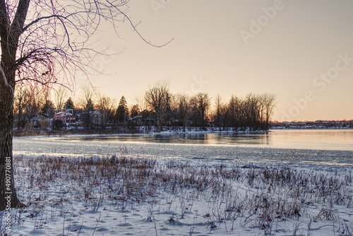 Beautiful sunset by the river at the beginning of winter with a clear sky