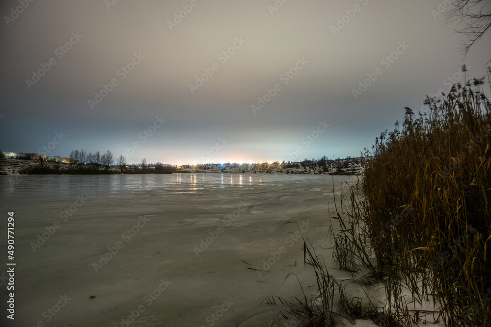 sunset over the river  forest in the night . Night landscape. Nightsky and clouds . Stars in the sky . Lights of the city . 