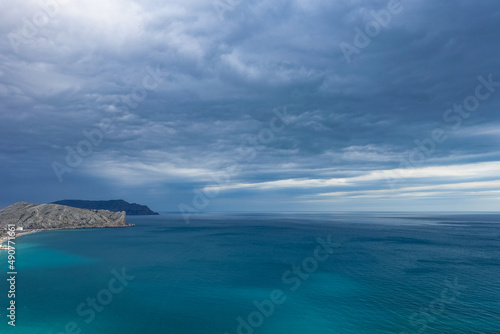 Crimea - May 2021. A line of beaches in the city of Sudak. View from the Genoese fortress on the Sudak Bay. Russia.