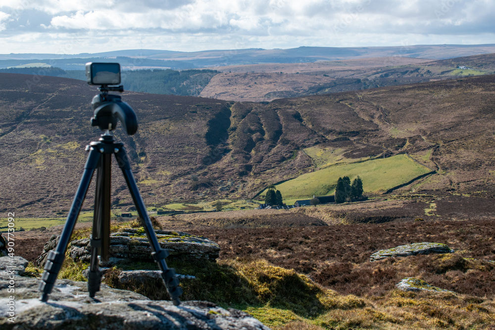 Taken at Grimspound on Dartmoor, this picture shows an action camera stood on a granite rock,  filming a timelapse video of the dramatic landscape.