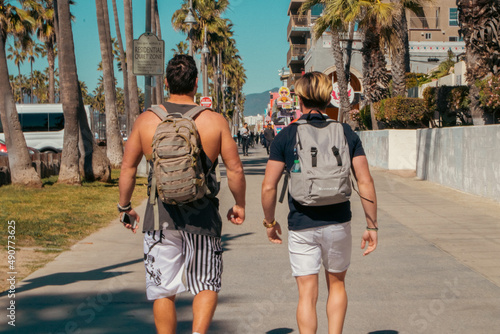 Two guys, tourists on Venice beach Los Angeles iconic sidewalk