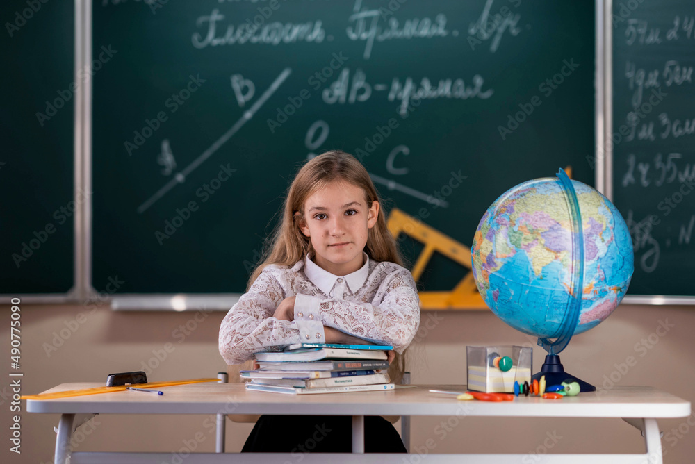 portrait of a schoolgirl in a classroom in a white blouse portrait of a schoolgirl in a classroom in a white blouse