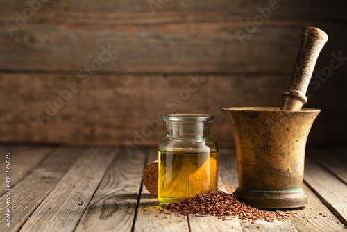 Flaxseeds, linseed oil, and old brass mortar.