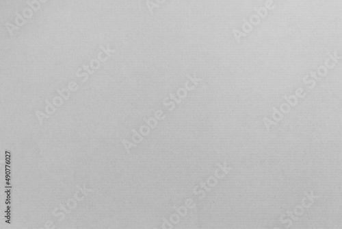 White carton sheet background texture. Horizontal stripes of the cardboard from packaging material. Blank page as backdrop for a design. Rough recycled paper surface.