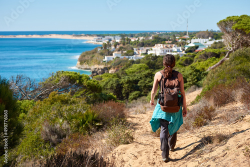 A young woman walking to Los Caños de la Meca, a coast town located in the Cadiz Province, Andalusia, Spain photo