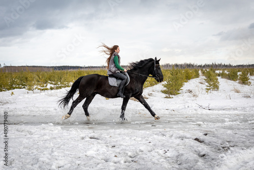 girl rides a horse. Walk with a horse through the countryside. fast jump