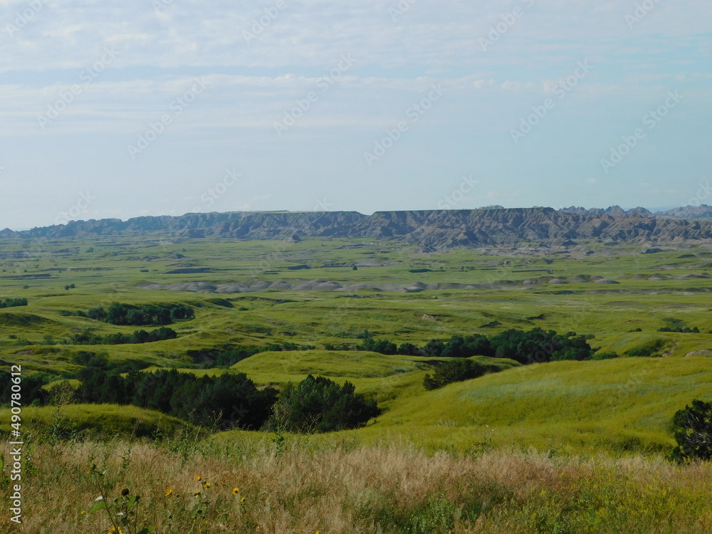 Green fields give way to the dramatic hillsides of the Badlands