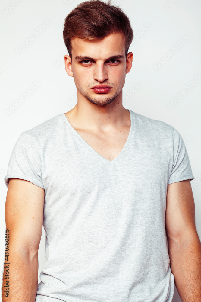 Obraz premium young handsome teenage hipster guy posing emotional, happy smiling against white background isolated, lifestyle people concept