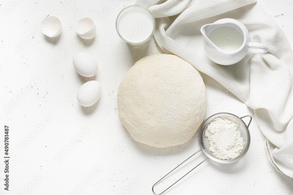 Fototapeta premium Raw dough with ingredients on light background