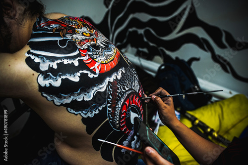 yakuza with dragon tattoo on back