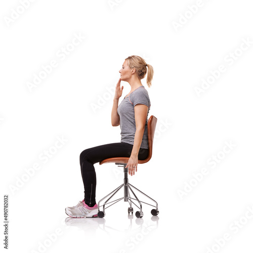 Perfect for your posture. Shot of a sporty woman doing stretches on a chair.