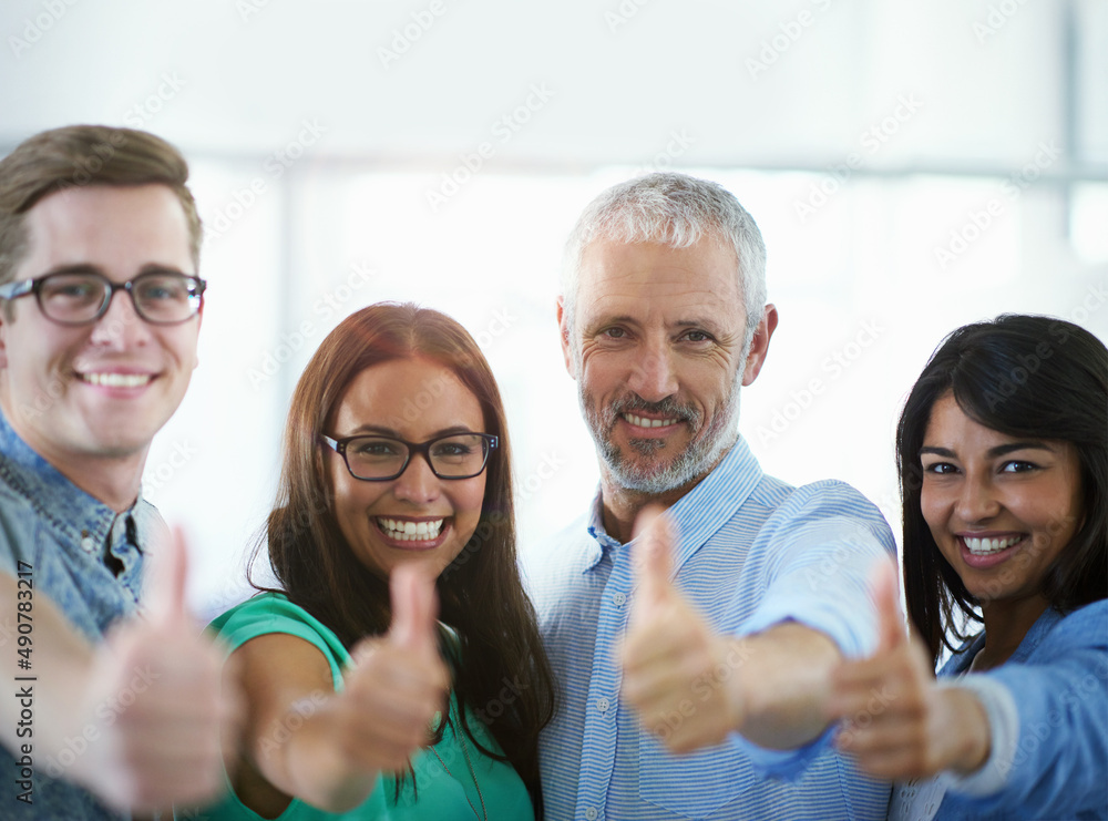 Well get the job done. Cropped portrait of a group of businesspeople giving the thumbs up. Well get the job done. Cropped portrait of a group of businesspeople giving the thumbs up.