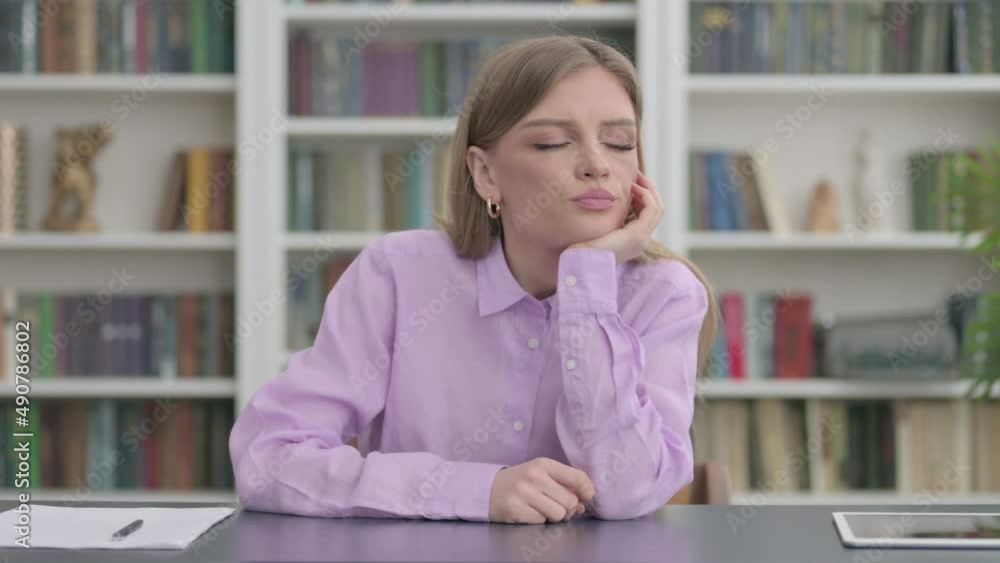 Tired Woman Sleeping While Sitting in Office