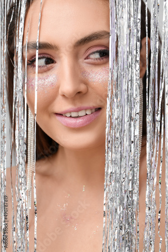 Young woman with glitter ma...