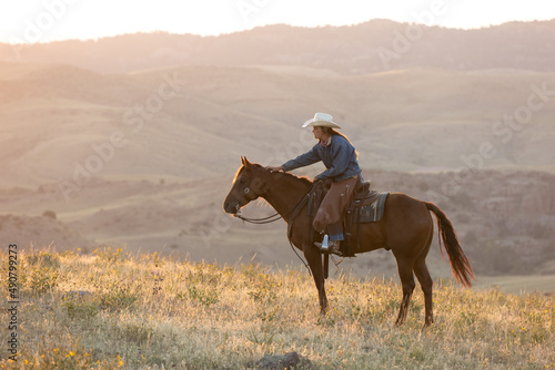 Fotografie Cowgirl on hilltop