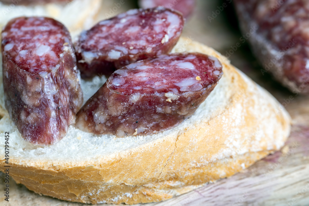 sliced pieces of sausage from meat are lying on a cutting board sliced pieces of sausage from meat are lying on a cutting board