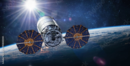 Fototapeta Naklejka Na Ścianę i Meble -  Cygnus spacecraft flight in space. Cygnus on orbit of Earth. Sci-fi wallpaper. Cargo expedition of Antares to ISS space station. Spaceship with astronauts. Elements of this image furnished by NASA 