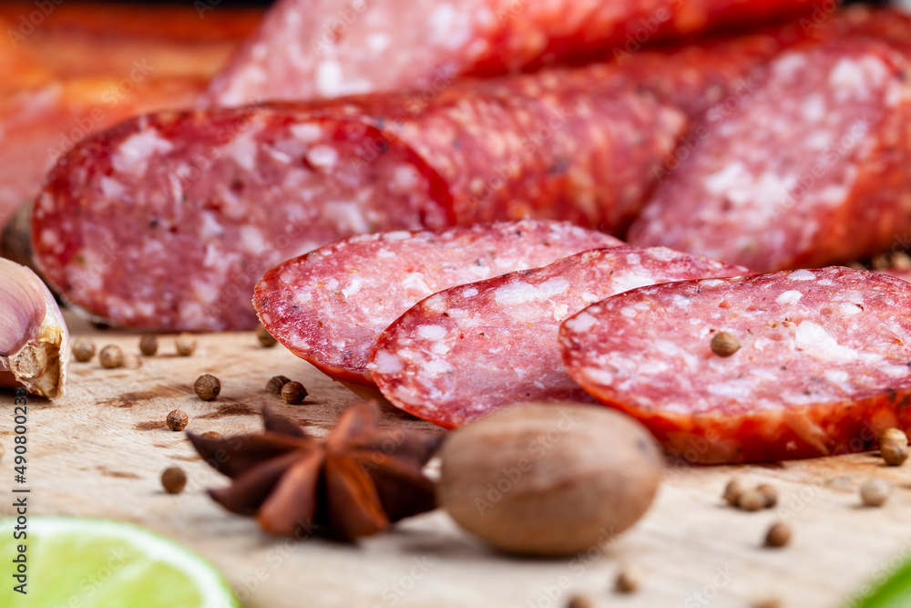 sliced pieces of sausage from meat are lying on a cutting board sliced pieces of sausage from meat are lying on a cutting board