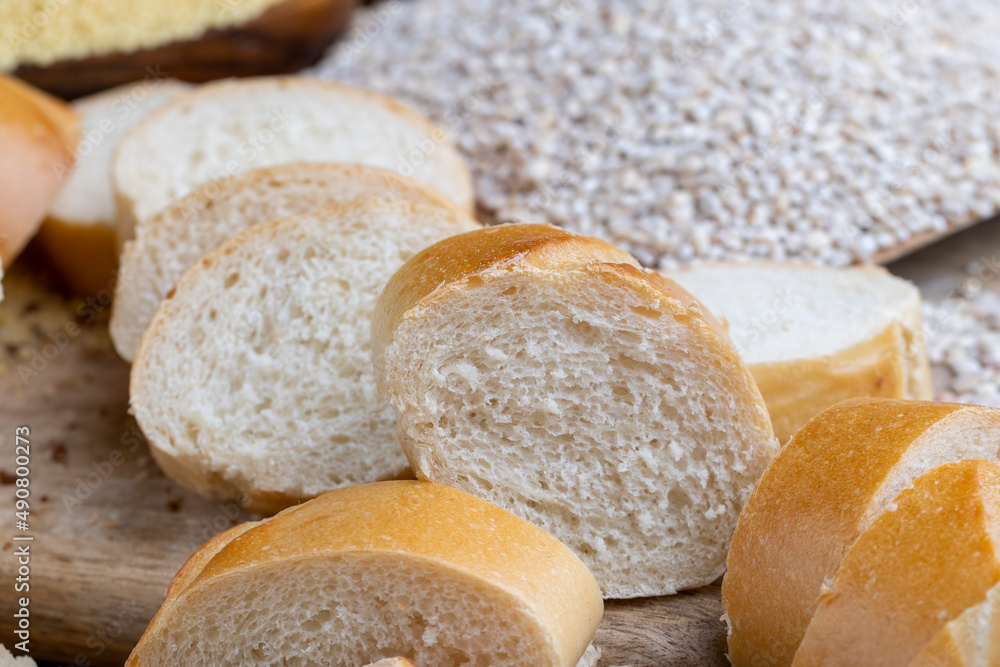 pieces of wheat baguette on a cutting board pieces of wheat baguette on a cutting board
