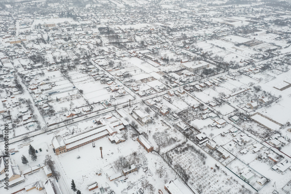 Fototapeta premium Snow-covered village, view from above. houses covered with snow, severe northern frosts
