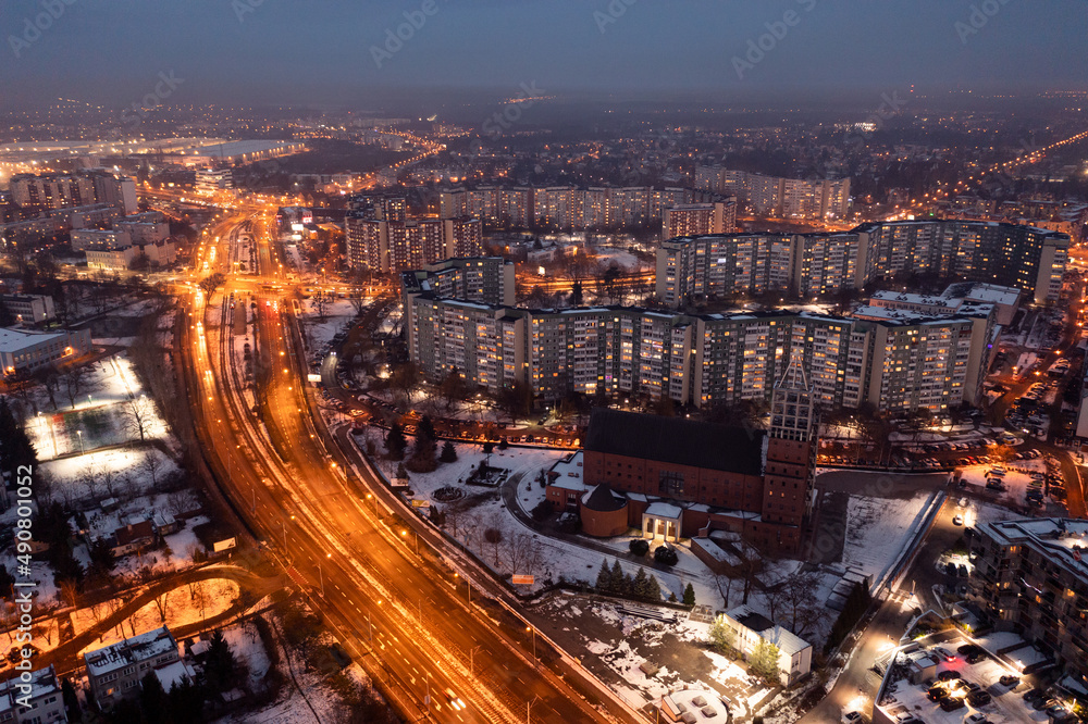 Aerial view of the evening Polish city of Wroclaw, illuminated streets and houses in the evening, roads in the city in the evening. urban landscape