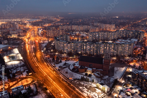 Aerial view of the evening Polish city of Wroclaw, illuminated streets and houses in the evening, roads in the city in the evening. urban landscape
