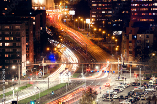 Abstract motion of winding city road with neon light motion effect. View from the top of the city street of the city of Wroclaw, Poland