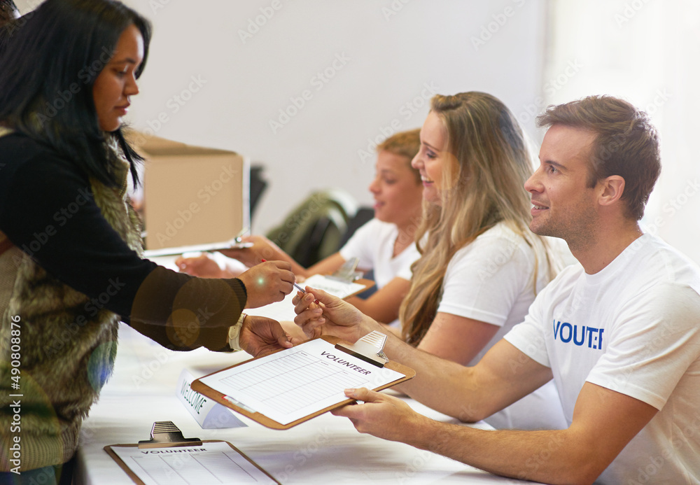 Just sign right here. Cropped shot of volunteer getting signatures for church donations. Just sign right here. Cropped shot of volunteer getting signatures for church donations.