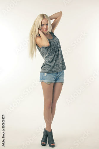 Hip and stylish. A young model in trendy clothing posing against a white background.