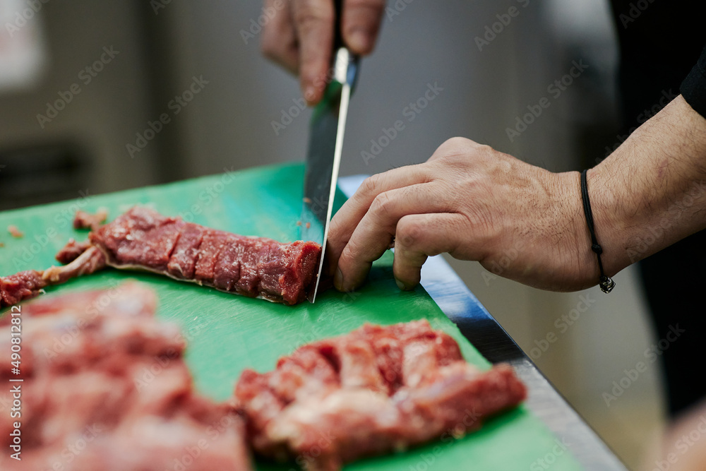 the chef cuts the meat of the lamb