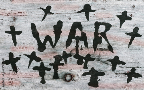 Krieg. Ein Holzschild mit Aufschrift WAR und Kreuzen photo
