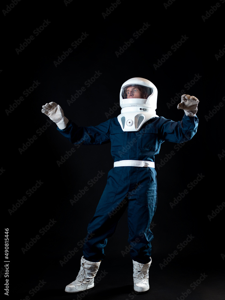The astronaut is floating in weightlessness. The hero of the science fiction story is a pioneer of space exploration. A young man in a space suit