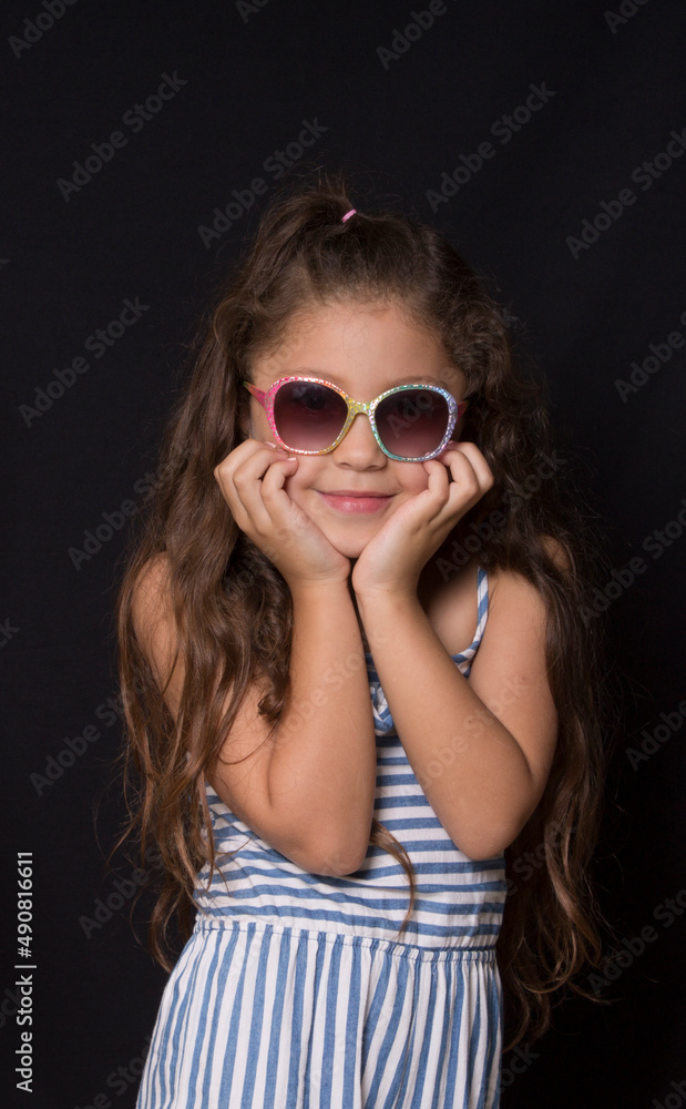 Fototapeta premium smiling caucasian girl with dark glasses portrait on black background 