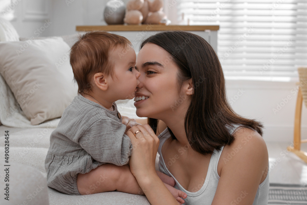 Young woman with her little baby at home