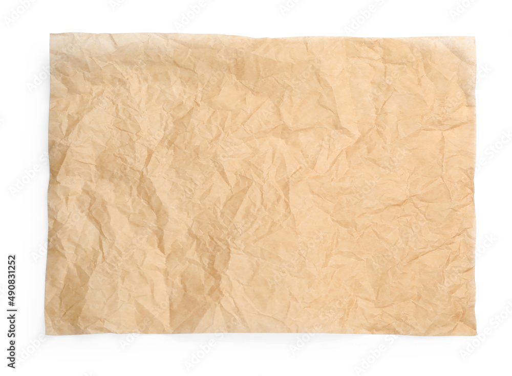 Sheet of crumpled brown baking paper on white background, top view