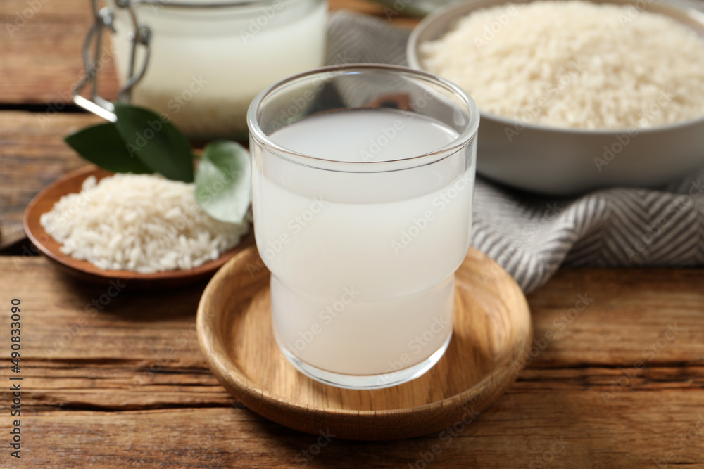 Glass of rice water on wooden table Glass of rice water on wooden table