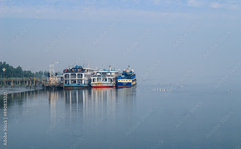 Tourist jetty of St. Martin's Island, Bangladesh. Photo of a seaport on an island with many ships docked. Good to use for outdoor and something about facilities or transporter content.