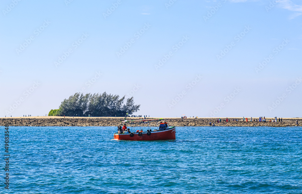 Small tourist ship with passengers. Beautiful seascape with a tourist boat. The ferry just left the pier. Small tourist ship with passengers. Beautiful seascape with a tourist boat. The ferry just left the pier.