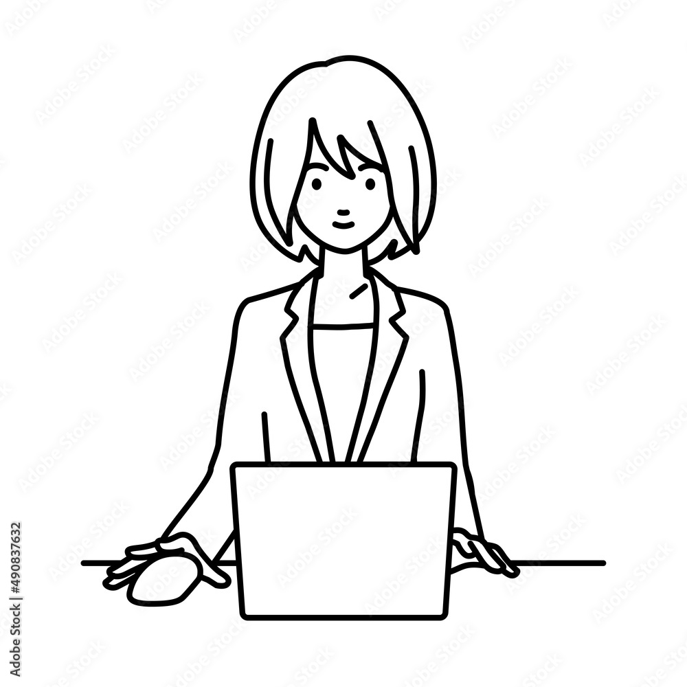 デスクで座ってPCを使っているスーツの女性 デスクで座ってPCを使っているスーツの女性