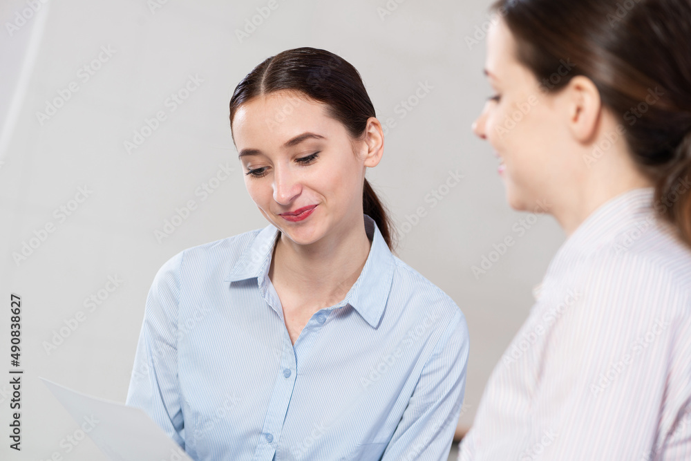 Young attractive woman talks to a colleague in the office Young attractive woman talks to a colleague in the office