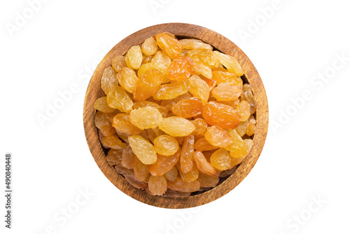 golden raisins in wooden bowl isolated on white background. Vegan food, top view.
