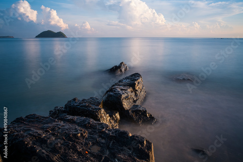 Long exposure of seascape rock beach and white cloud background