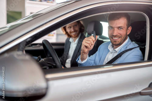 Young caucasian male buying a car in the store © luckybusiness