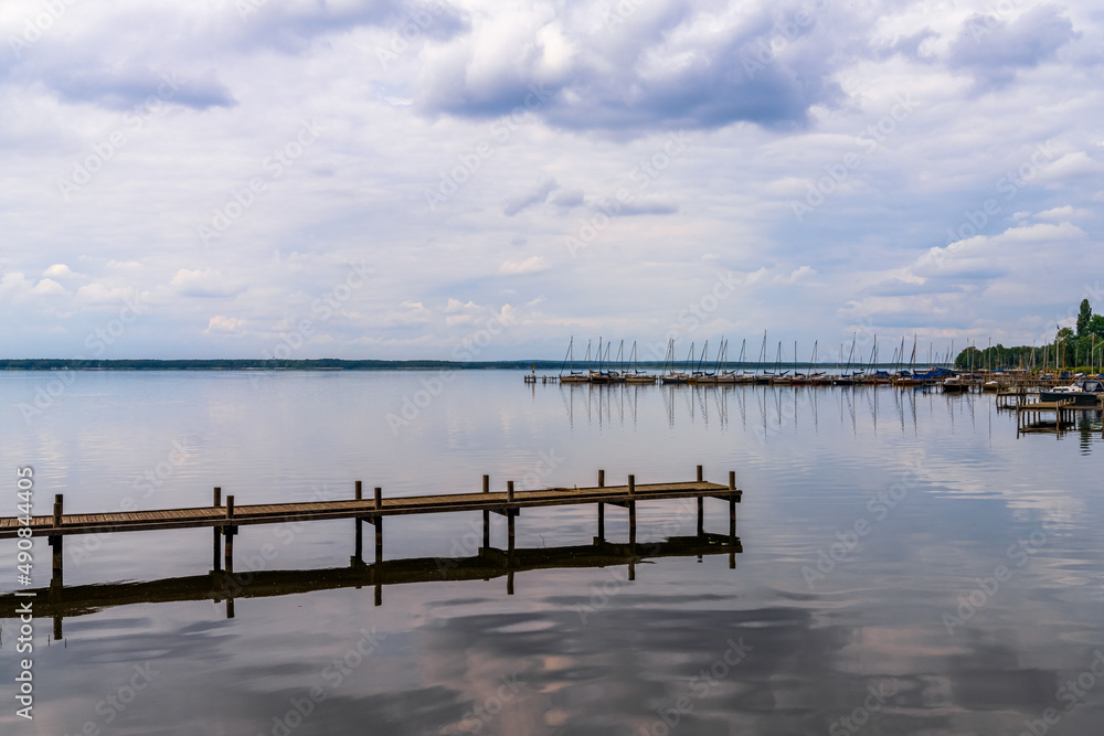 A jetty at the Steinhuder Meer with some boats in the background, seen in Steinhude, Lower Saxony, Germany