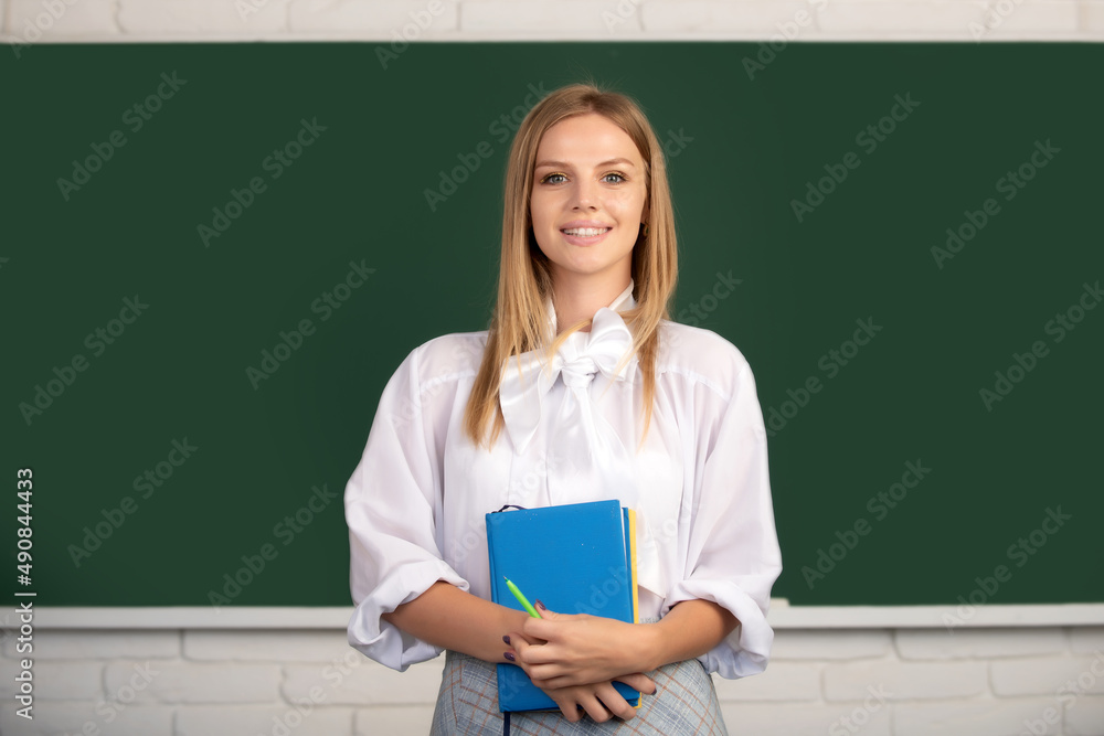 Student holding book, preparing exam and learning lessons in school classroom. Student holding book, preparing exam and learning lessons in school classroom.