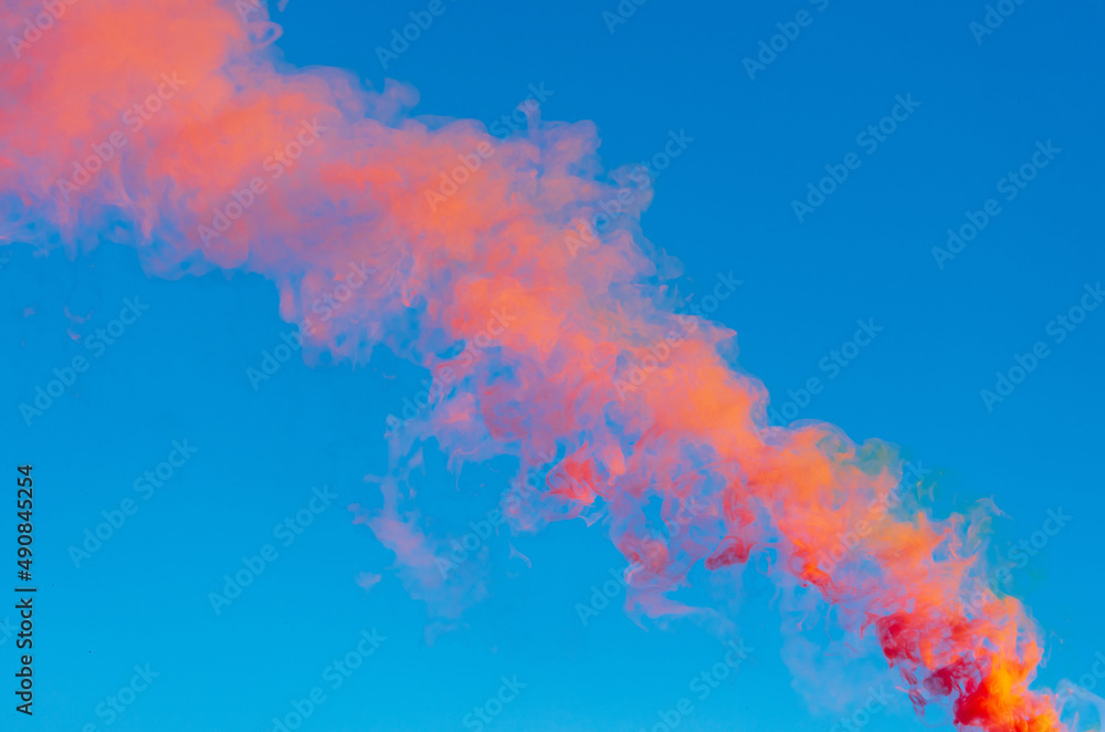 Red smoke on a blue background.