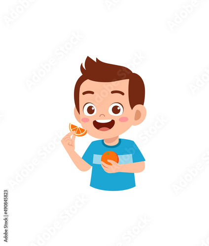 little boy holding fresh orange fruit from farm