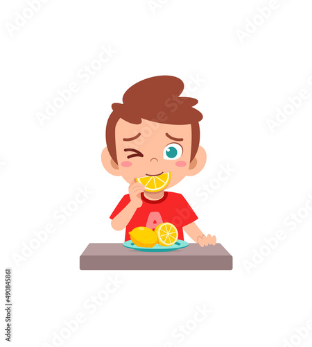 little boy eat sour lemon and show funny expression